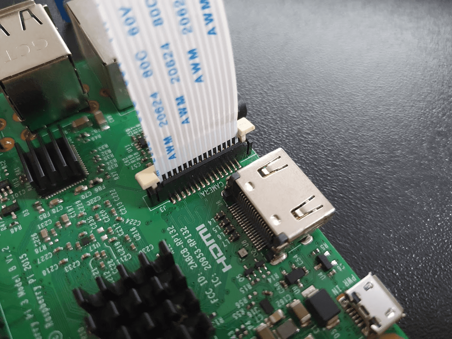 Pull up the locking tab and insert the cable with the pins facing the connector pins